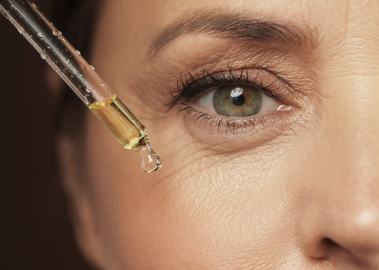 Mujer aplicando sérum facial piel radiante cuidado post-verano